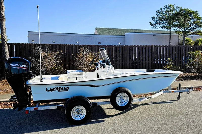 Slide: The Image of 2026 Mako Pro Skiff 15 CC boat on trailer with Mercury outboard motor. - 0