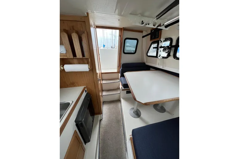 Slide: The Image of Interior of 2001 Skipjack 262 Flybridge boat with dining area and kitchenette. - 11