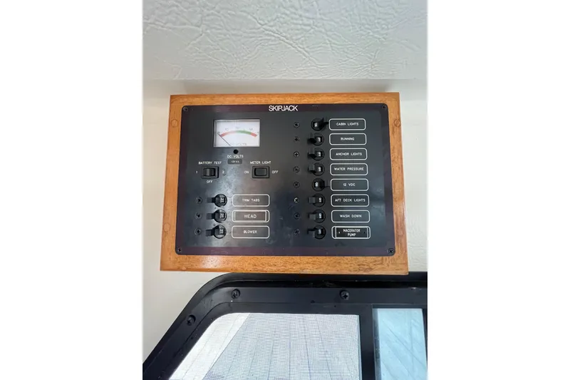 Slide: The Image of Control panel of a 2001 Skipjack 262 Flybridge boat with various switches and gauges. - 14