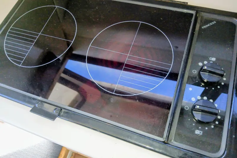 Slide: The Image of Electric stove on 2001 Skipjack 262 Flybridge boat, featuring dual burners and control knobs. - 17