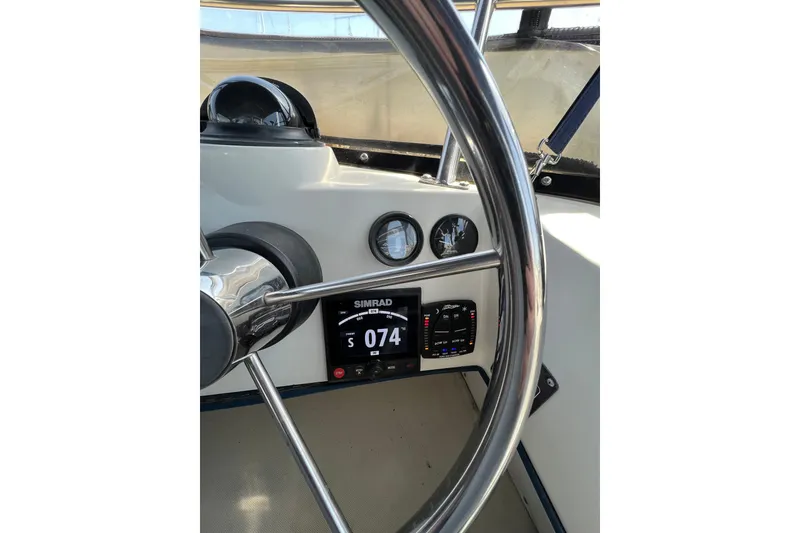 Slide: The Image of Steering wheel and dashboard of 2001 Skipjack 262 Flybridge boat with navigation instruments. - 6