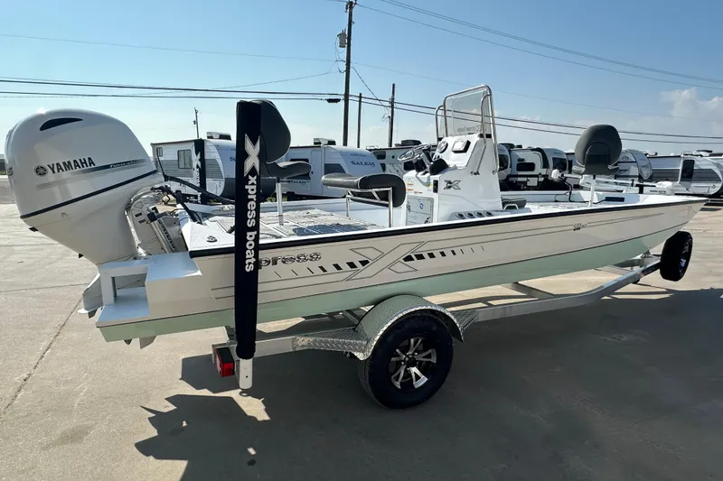 Slide: The Image of 2026 Xpress SW20B boat with Yamaha engine on trailer, parked outdoors. - 3