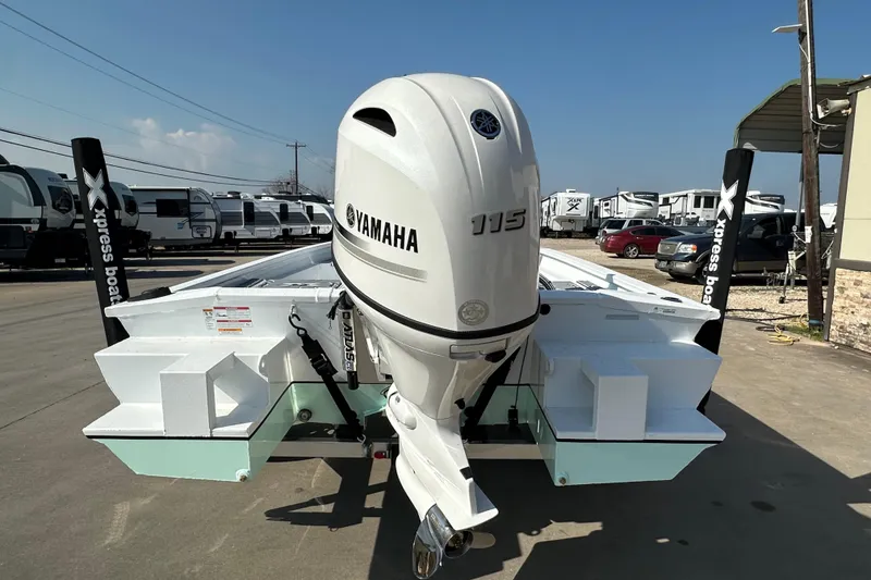 Slide: The Image of 2026 Xpress SW20B boat with Yamaha 115 engine, parked outdoors. - 4