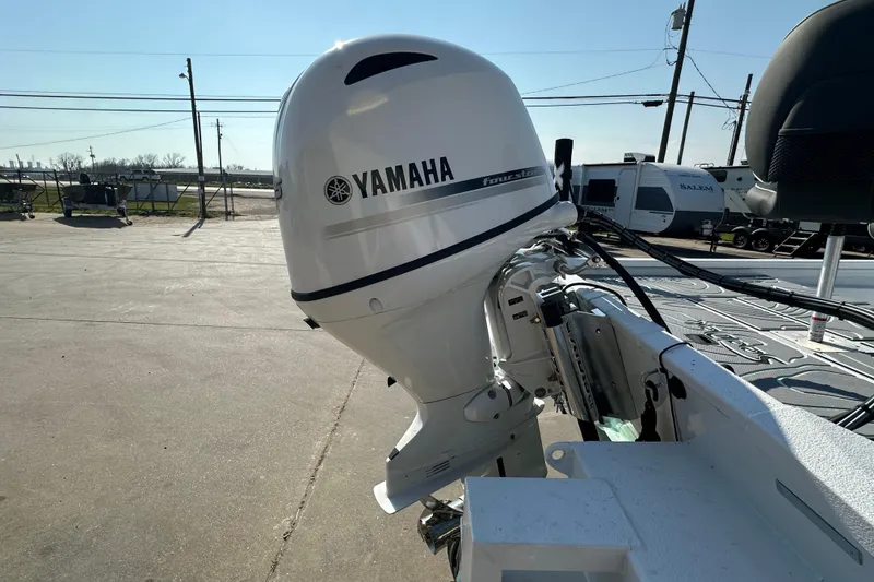 Slide: The Image of Yamaha outboard motor on 2026 Xpress SW20B boat, parked outdoors. - 7