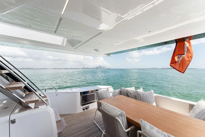 Slide: The Image of Luxury Ferretti Yachts 780, 2023 model, with ocean view and city skyline in background. - 14