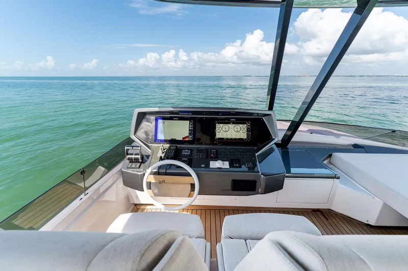 Slide: The Image of 2023 Ferretti Yachts 780 helm with modern navigation systems, overlooking the ocean. - 26
