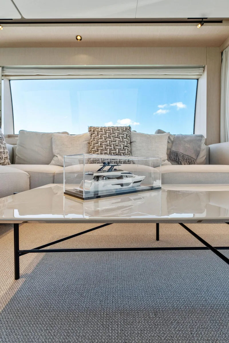 Slide: The Image of Model of 2023 Ferretti Yachts 780 displayed on a luxurious yacht interior table. - 32