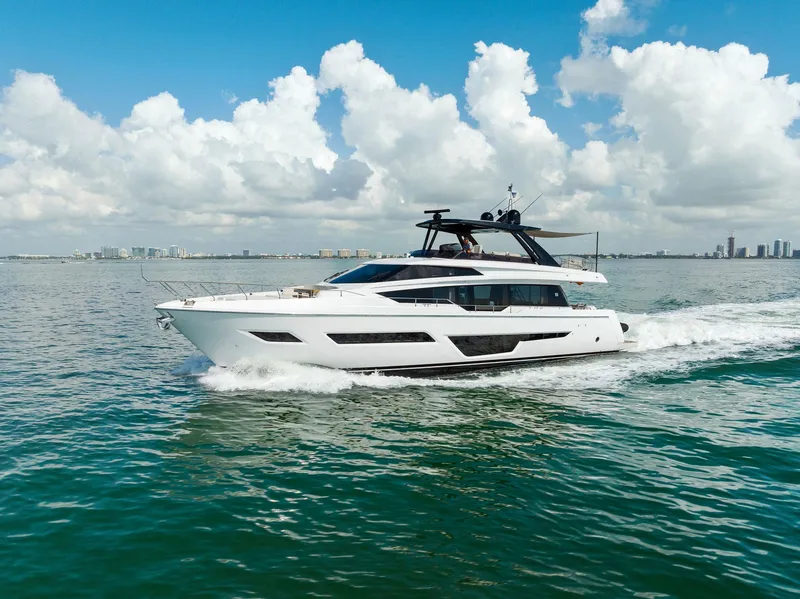The Image of 2023 Ferretti Yachts 780 cruising on calm blue waters, scenic coastal backdrop. - 0