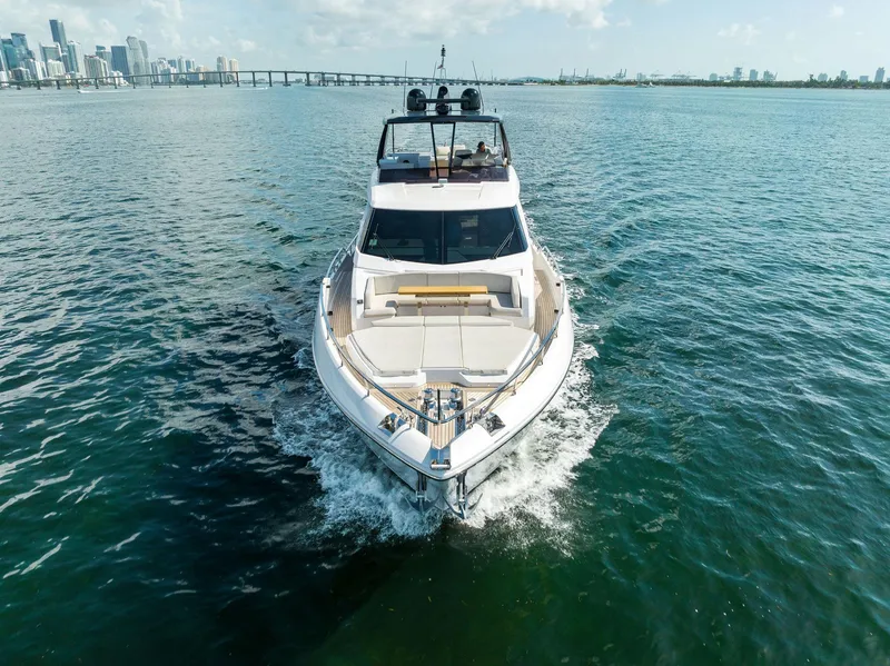 Slide: The Image of 2023 Ferretti Yachts 780 cruising near city skyline under blue sky. - 2