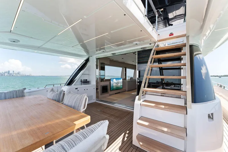 Slide: The Image of 2023 Ferretti Yachts 780 cruising on open water with city skyline backdrop. - 6