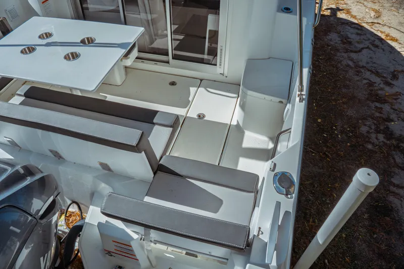 Slide: The Image of 2024 Jeanneau NC 795 Series 2 boat interior with seating and table setup. - 12