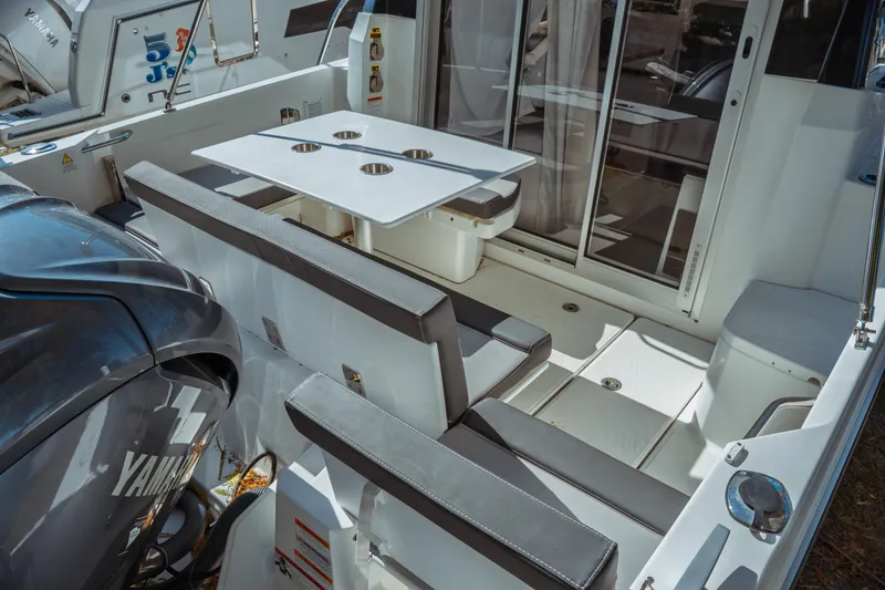 Slide: The Image of 2024 Jeanneau NC 795 Series 2 boat interior with seating and table setup. - 13