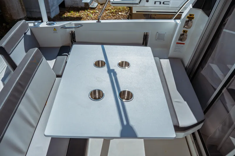 Slide: The Image of 2024 Jeanneau NC 795 Series 2 boat interior with table and seating area. - 18