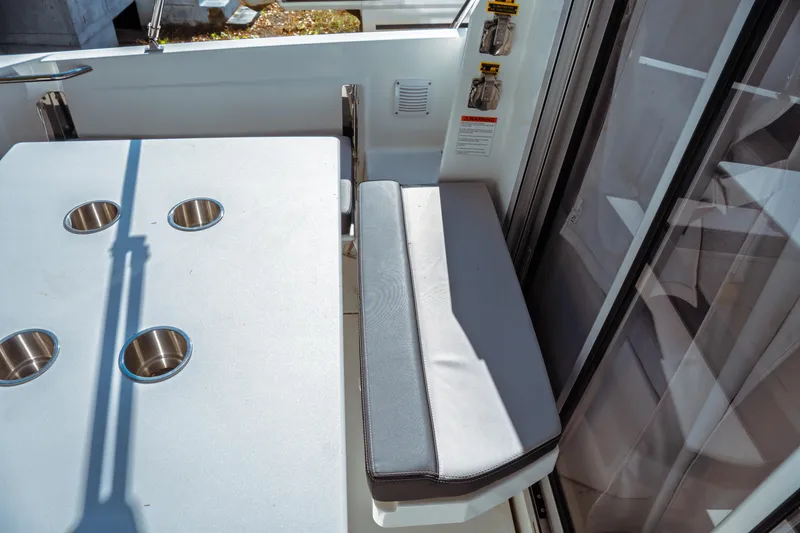 Slide: The Image of 2024 Jeanneau NC 795 Series 2 boat interior with table and seating area. - 19