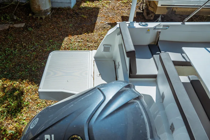Slide: The Image of 2024 Jeanneau NC 795 Series 2 boat interior with seating and engine view. - 20