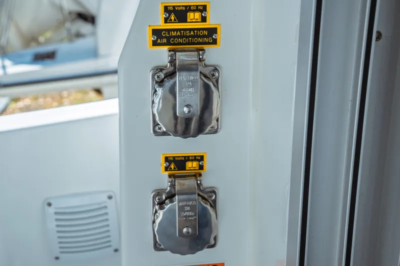 Slide: The Image of Electrical outlets on 2024 Jeanneau NC 795 Series 2 boat, labeled for air conditioning. - 22