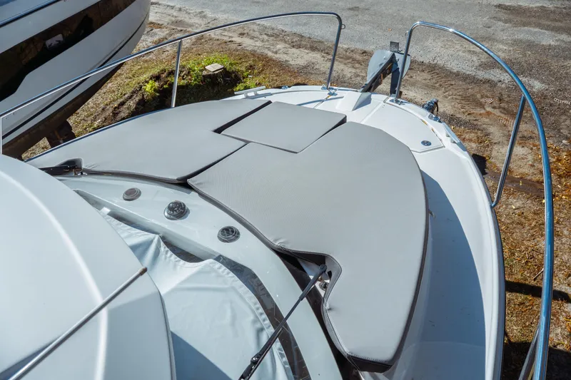 Slide: The Image of 2024 Jeanneau NC 795 Series 2 boat with cushioned deck, docked on land. - 27