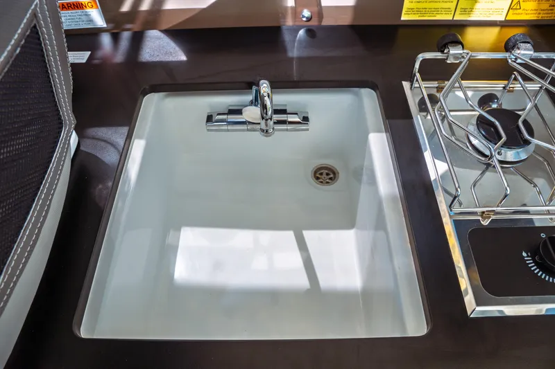 Slide: The Image of 2024 Jeanneau NC 795 Series 2 boat kitchen sink and stove detail. - 31