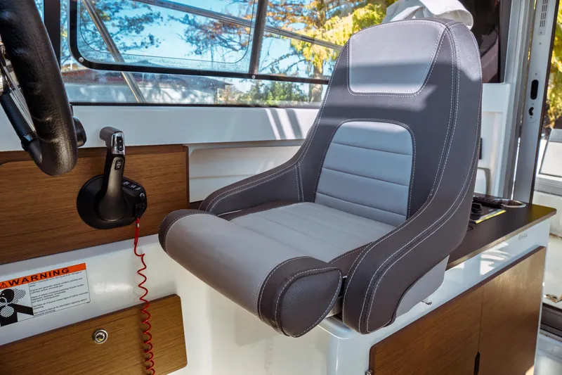Slide: The Image of 2024 Jeanneau NC 795 Series 2 helm seat with modern design and controls. - 35