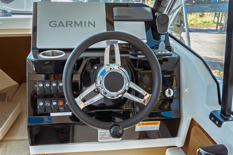 Slide: The Image of 2024 Jeanneau NC 795 Series 2 helm with Garmin navigation and modern controls. - 36