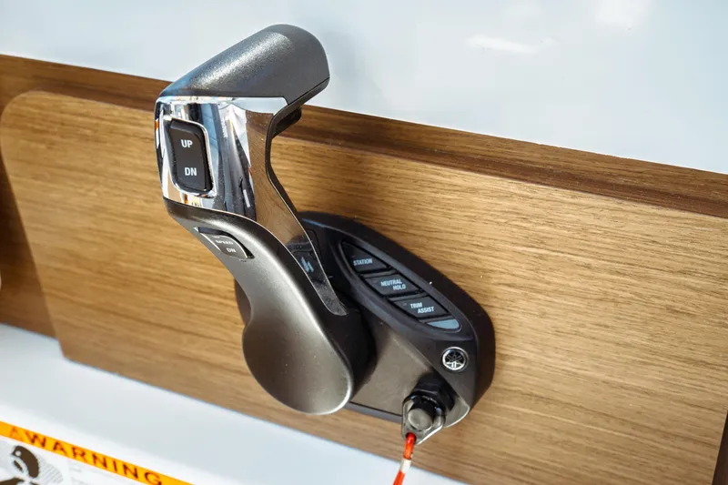 Slide: The Image of Throttle control lever on 2024 Jeanneau NC 795 Series 2 boat dashboard. - 40