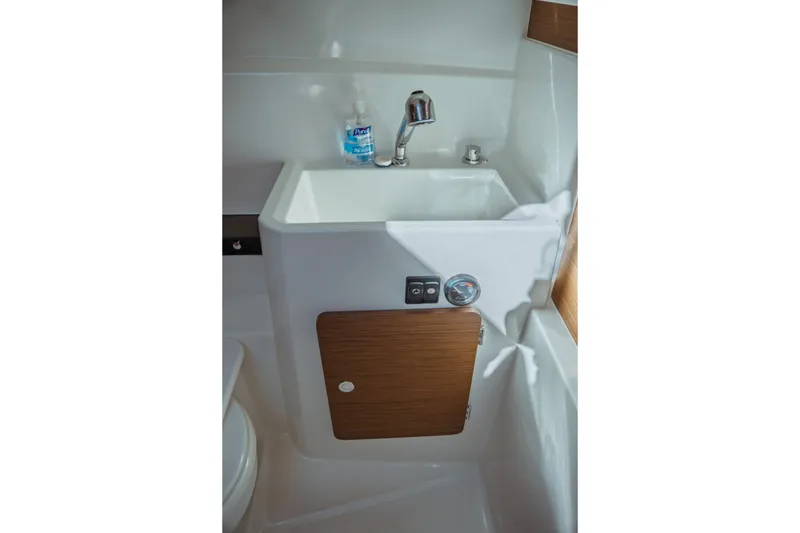 Slide: The Image of 2024 Jeanneau NC 795 Series 2 bathroom sink with faucet and storage cabinet. - 47