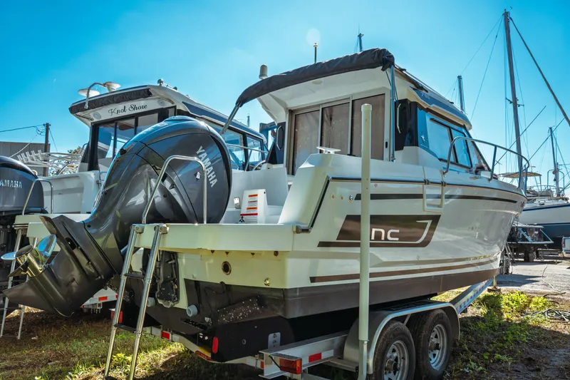 Slide: The Image of 2024 Jeanneau NC 795 Series 2 boat with Yamaha outboard motor on trailer. - 5