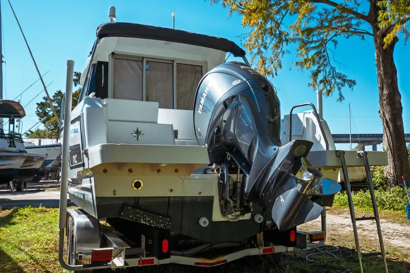Slide: The Image of 2024 Jeanneau NC 795 Series 2 boat with Yamaha outboard motor, parked outdoors. - 7