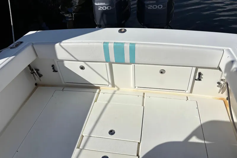 Slide: The Image of 1995 Whitewater 28 boat deck with storage compartments and Yamaha 200 engines. - 10
