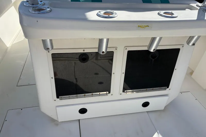 Slide: The Image of 1995 Whitewater 28 boat interior with rod holders and storage compartments. - 13