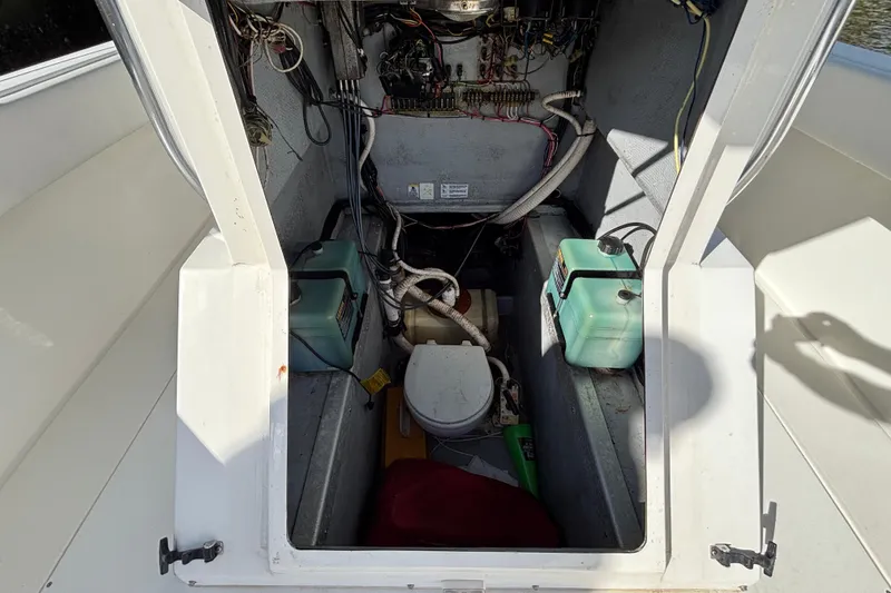 Slide: The Image of Interior view of a 1995 Whitewater 28 boat showing wiring and storage compartments. - 9