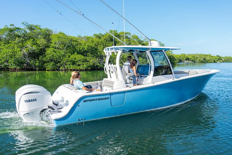 Slide: The Image of Manufacturer Provided Image: 2025 Sportsman Open 302 Center Console boat cruising on a calm waterway. - 2