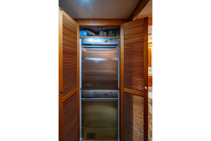 Slide: The Image of Stainless steel appliances in 2006 Krogen 58 yacht kitchen with wooden cabinetry. - 32