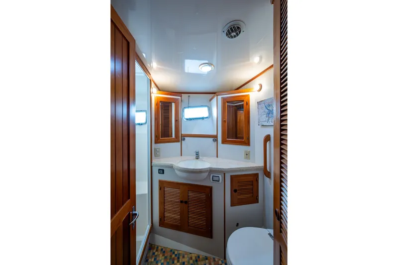 Slide: The Image of Luxurious 2006 Krogen 58 yacht bathroom with wooden cabinetry and modern fixtures. - 37