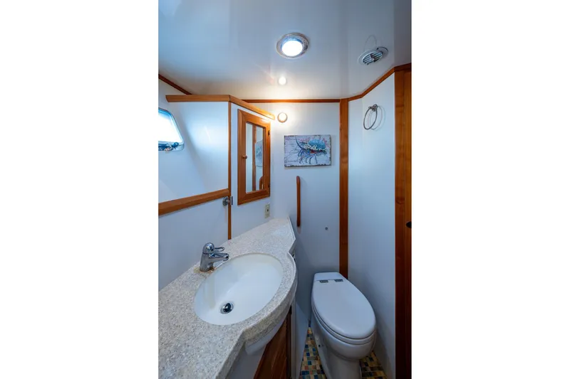 Slide: The Image of Bathroom interior of 2006 Krogen 58 yacht with sink, toilet, and mirror. - 38