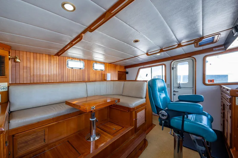 Slide: The Image of Interior of 2006 Krogen 58 yacht with seating, table, and captain's chair. - 40