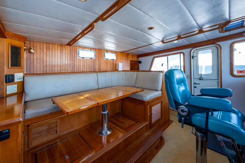Slide: The Image of Interior of 2006 Krogen 58 yacht with wooden paneling and blue captain's chair. - 41