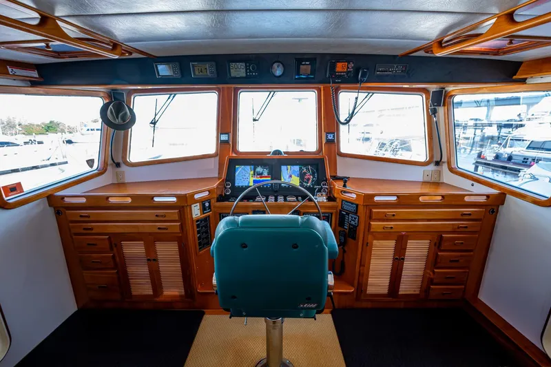 Slide: The Image of Pilothouse interior of 2006 Krogen 58 yacht with navigation equipment and wooden cabinetry. - 42
