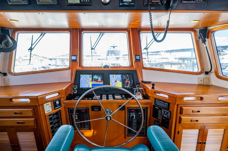 Slide: The Image of Pilothouse of 2006 Krogen 58 yacht with navigation equipment and wooden interior. - 45
