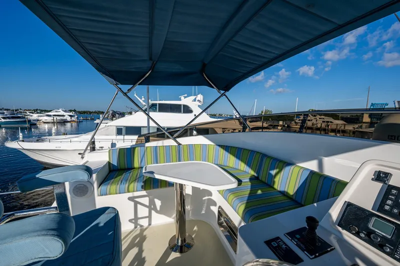 Slide: The Image of 2006 Krogen 58 yacht interior with striped seating and marina view. - 47