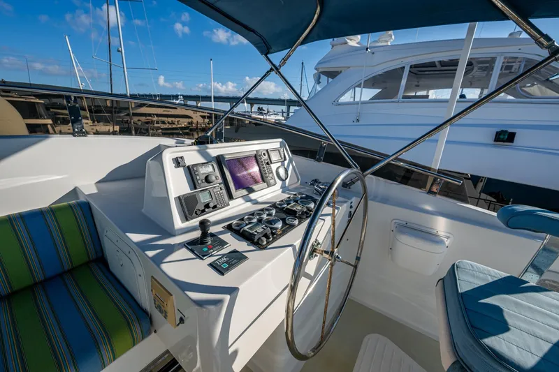 Slide: The Image of Helm of 2006 Krogen 58 yacht with navigation equipment and seating. - 48