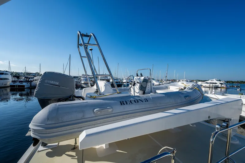 Slide: The Image of 2006 Krogen 58 yacht with dinghy and Yamaha motor at marina. - 51