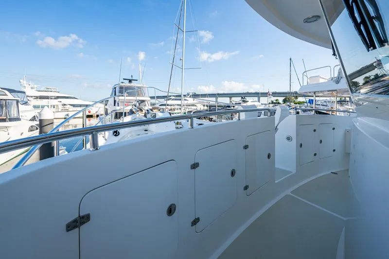 Slide: The Image of 2006 Krogen 58 yacht deck with marina view, featuring sleek design and storage compartments. - 55