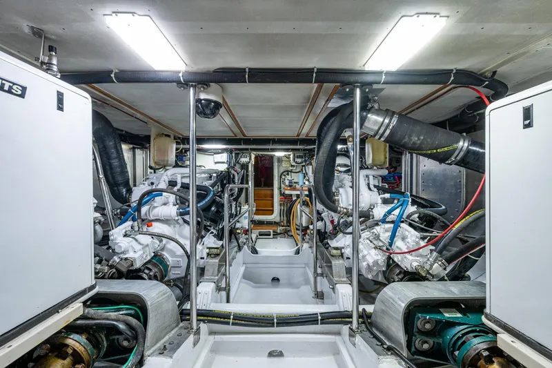 Slide: The Image of Engine room of a 2006 Krogen 58 yacht, showcasing dual engines and mechanical systems. - 60