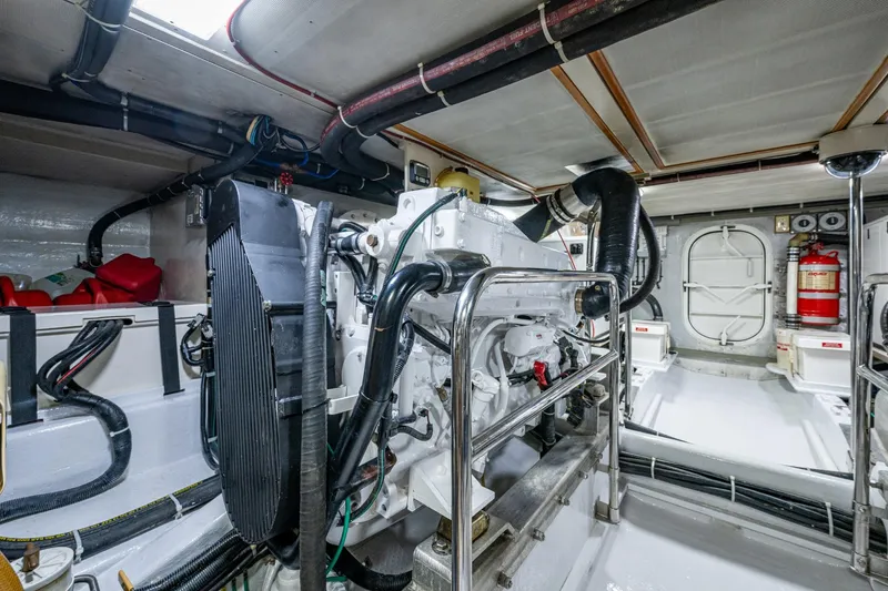 Slide: The Image of Engine room of a 2006 Krogen 58 yacht, featuring machinery and safety equipment. - 64