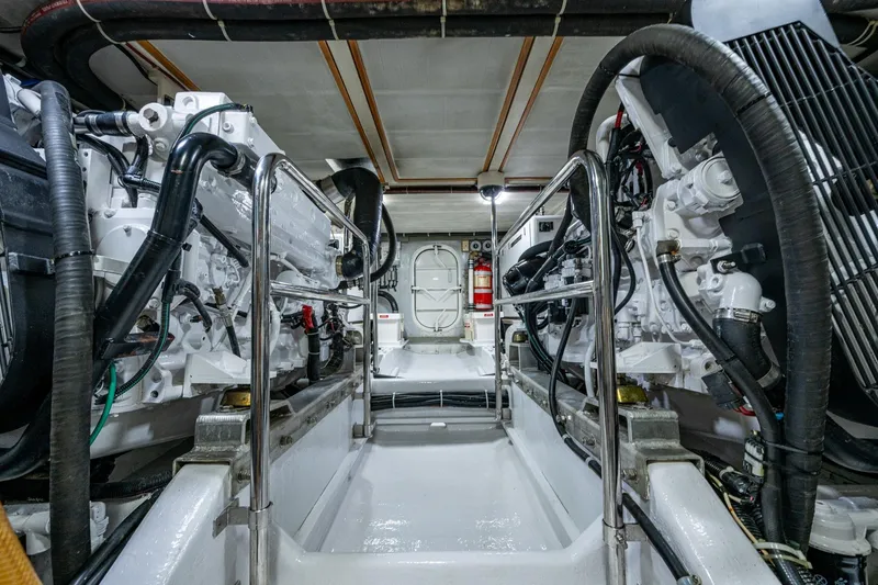 Slide: The Image of Engine room of 2006 Krogen 58 yacht, featuring dual engines and safety equipment. - 65