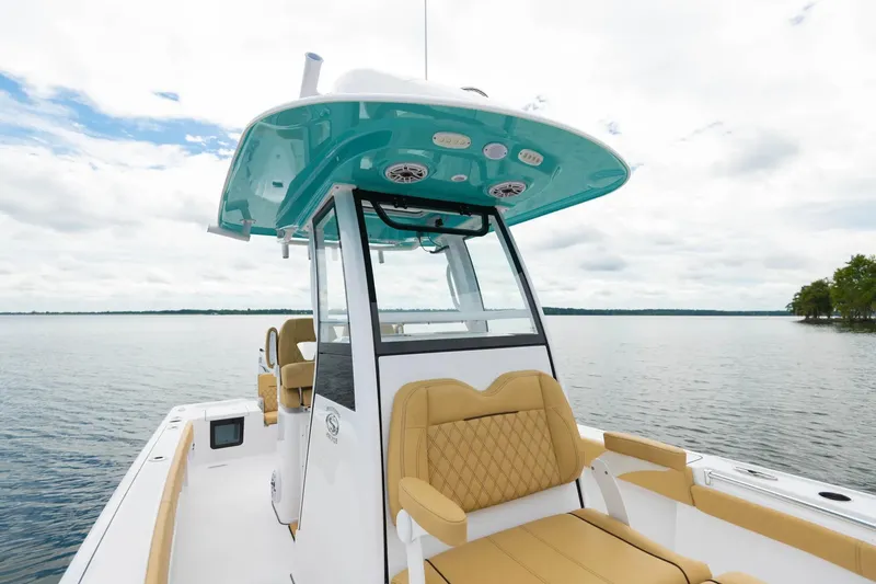 Slide: The Image of Manufacturer Provided Image: 2025 Sportsman Masters 267OE Bay Boat on calm water, featuring modern design and seating. - 6