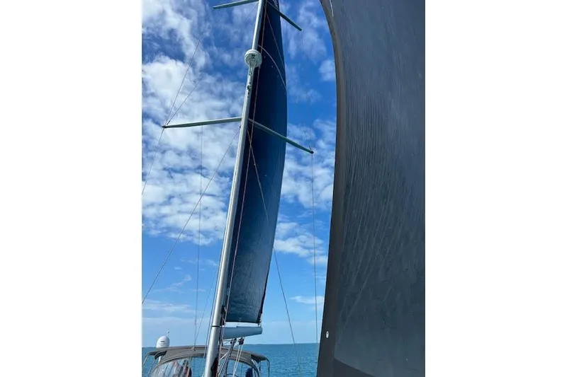 Slide: The Image of Sailing on a 2016 Jeanneau 54 yacht with blue skies and ocean view. - 10