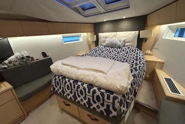 Slide: The Image of Luxurious cabin interior of 2016 Jeanneau 54 yacht with cozy bedding and modern design. - 15