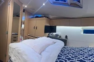 Slide: The Image of Interior of 2016 Jeanneau 54 yacht cabin with modern furnishings and cozy bedding. - 19